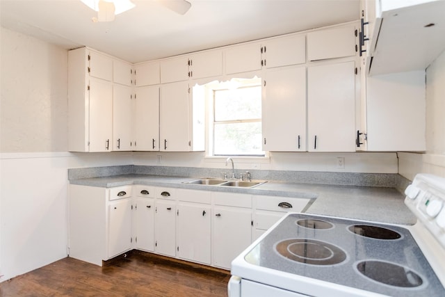 kitchen with light countertops, white electric range, dark wood-type flooring, white cabinets, and a sink