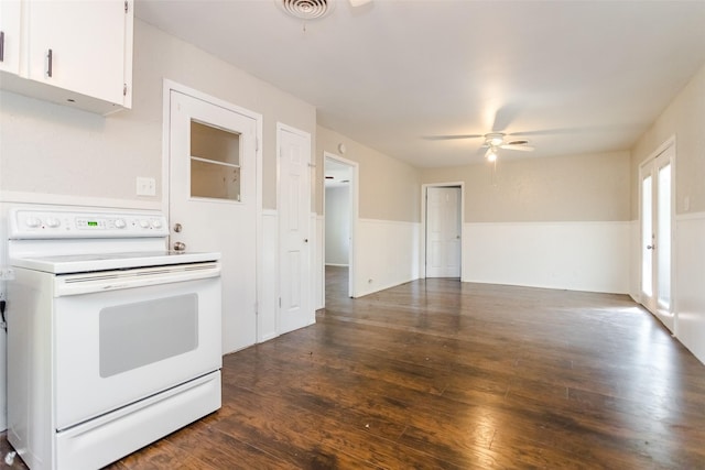 kitchen featuring dark wood-style floors, a wainscoted wall, white electric range, visible vents, and ceiling fan