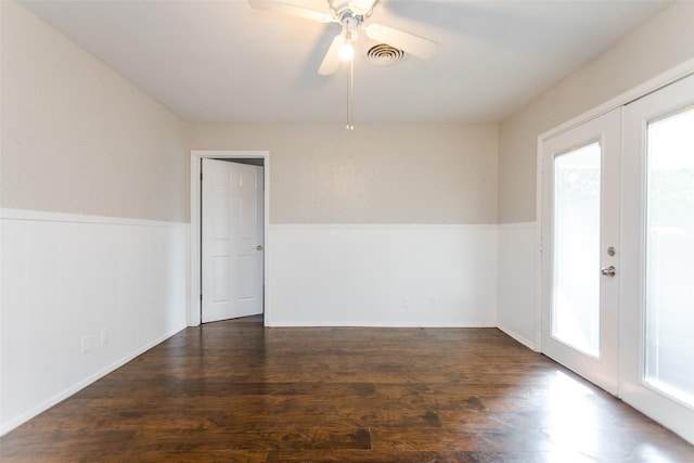 unfurnished room featuring ceiling fan, wood finished floors, visible vents, french doors, and wainscoting