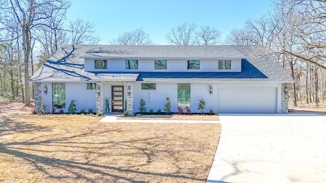 view of front facade with stone siding, concrete driveway, an attached garage, and stucco siding