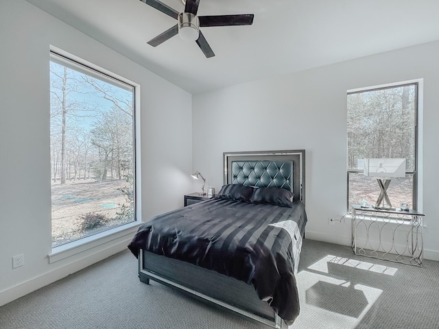 bedroom featuring baseboards, a ceiling fan, and carpet