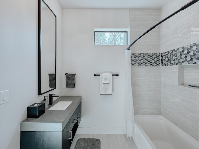 bathroom with baseboards, wood finished floors, shower / tub combo with curtain, and vanity