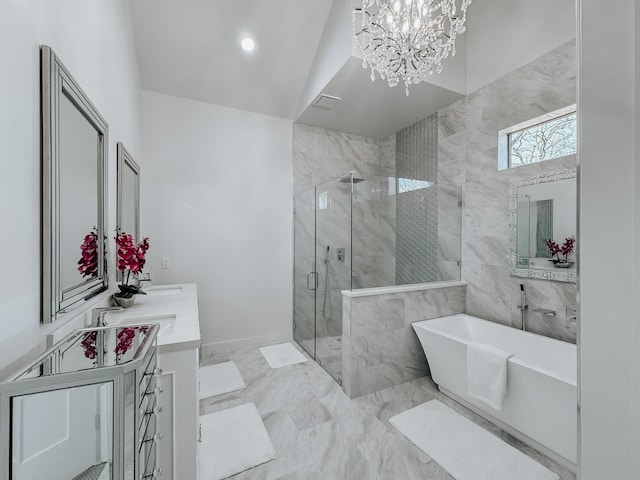 full bathroom with a stall shower, a chandelier, marble finish floor, double vanity, and a freestanding bath