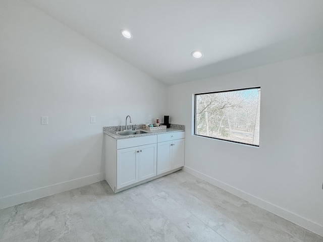 clothes washing area featuring recessed lighting, baseboards, and a sink
