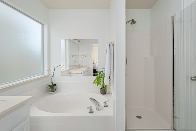 bathroom with a bath, a stall shower, vanity, and a healthy amount of sunlight