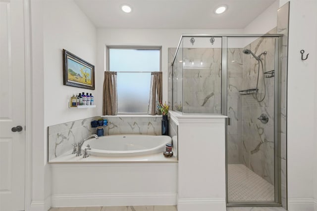 bathroom with recessed lighting, a garden tub, and a marble finish shower