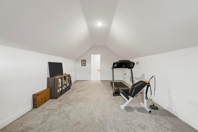 workout area featuring vaulted ceiling, carpet floors, and baseboards