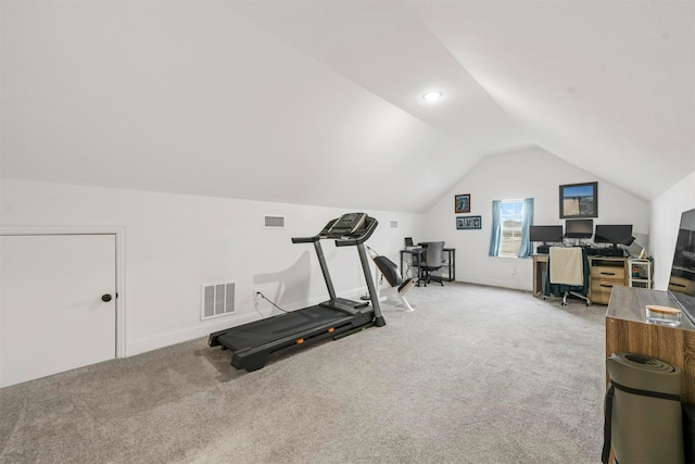 workout area featuring baseboards, visible vents, vaulted ceiling, and carpet flooring