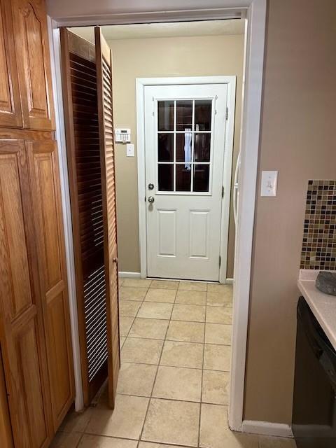 909 Harwell St, Abilene, TX 79601 - doorway with baseboards and light tile patterned floors
