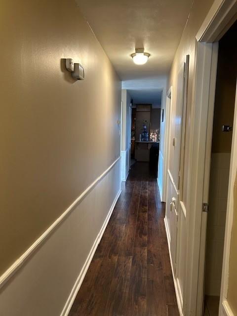 909 Harwell St, Abilene, TX 79601 - corridor featuring dark wood finished floors and baseboards