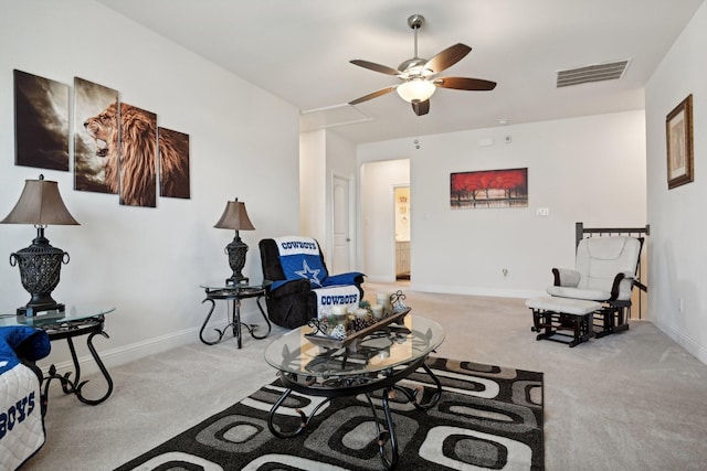 living area featuring baseboards, visible vents, ceiling fan, and carpet flooring