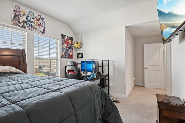 bedroom featuring baseboards, vaulted ceiling, and light colored carpet