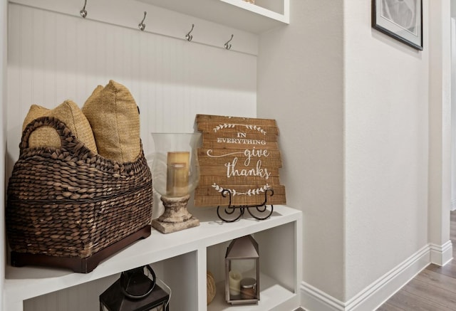 mudroom with baseboards and wood finished floors