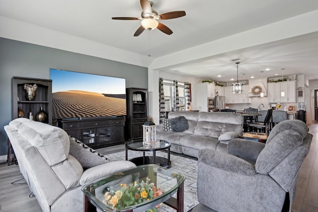 living area featuring recessed lighting, light wood-style flooring, and a ceiling fan