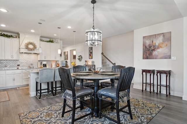 dining space featuring baseboards, a chandelier, wood finished floors, and recessed lighting