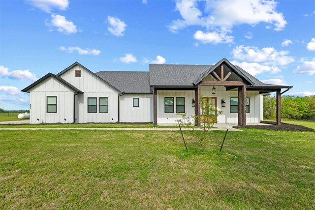 modern inspired farmhouse with a front lawn and board and batten siding