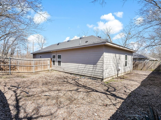 back of house featuring a fenced backyard