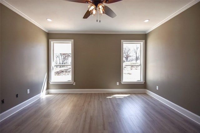 unfurnished room with ceiling fan, baseboards, wood finished floors, and ornamental molding