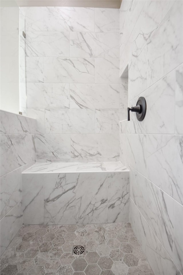 bathroom with tiled shower