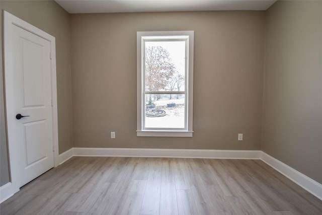 unfurnished room featuring light wood-style flooring and baseboards