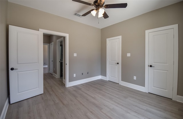 unfurnished bedroom with visible vents, a ceiling fan, light wood-type flooring, and baseboards