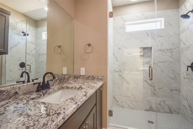 bathroom featuring vanity and a shower stall