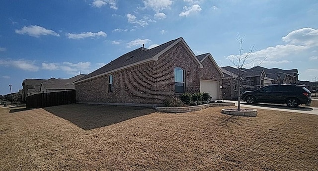 view of home's exterior featuring a garage and brick siding