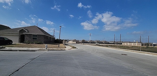 view of street with sidewalks, street lighting, and curbs