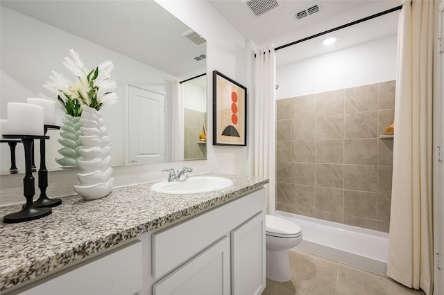 full bath with a stall shower, visible vents, vanity, and toilet