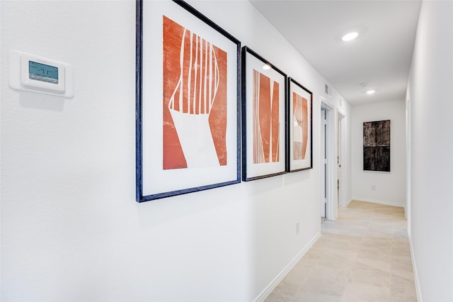 hallway featuring recessed lighting, visible vents, and baseboards