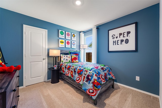 bedroom featuring carpet and baseboards