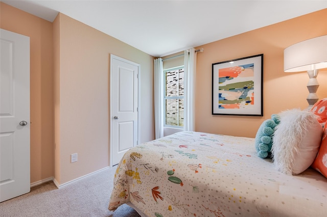 bedroom featuring carpet floors and baseboards