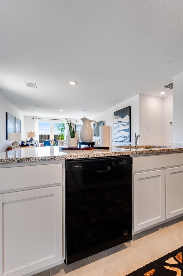 kitchen with white cabinetry, visible vents, light stone counters, and dishwasher