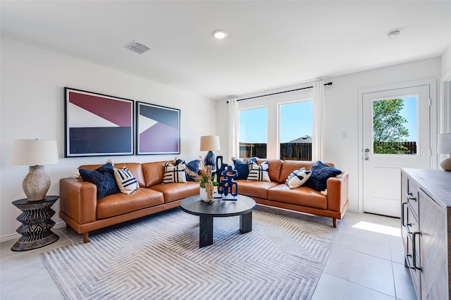 living area with light tile patterned floors and visible vents