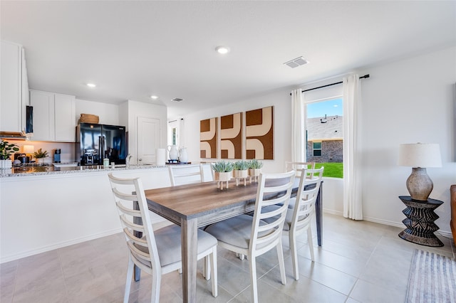 dining space featuring baseboards, light tile patterned flooring, visible vents, and recessed lighting