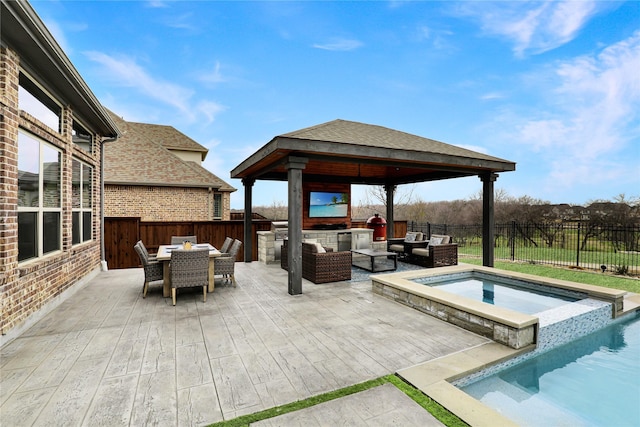 view of patio / terrace featuring a fenced backyard, an outdoor hangout area, an in ground hot tub, outdoor dining area, and a gazebo