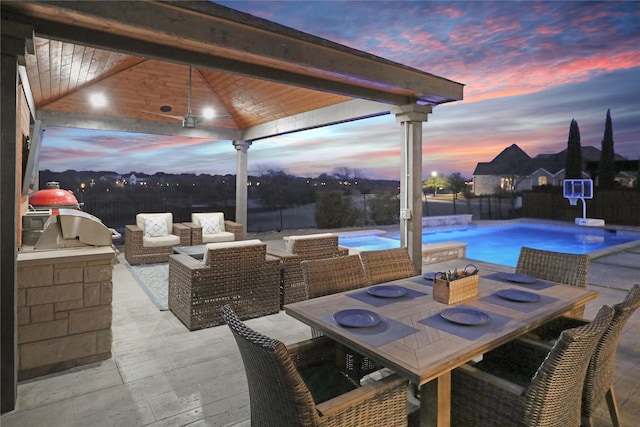 view of patio featuring a fenced in pool, outdoor dining area, an outdoor hangout area, exterior kitchen, and fence private yard