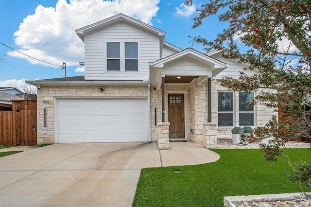 view of front of home with stone siding, a front lawn, fence, and driveway