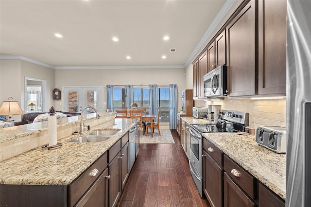 kitchen with a toaster, dark wood-type flooring, stainless steel appliances, crown molding, and a sink