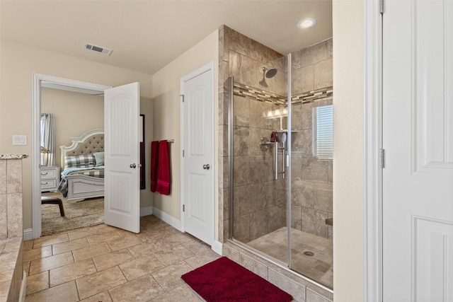 bathroom with a stall shower, baseboards, visible vents, and connected bathroom