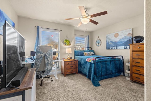 carpeted bedroom featuring a ceiling fan and baseboards