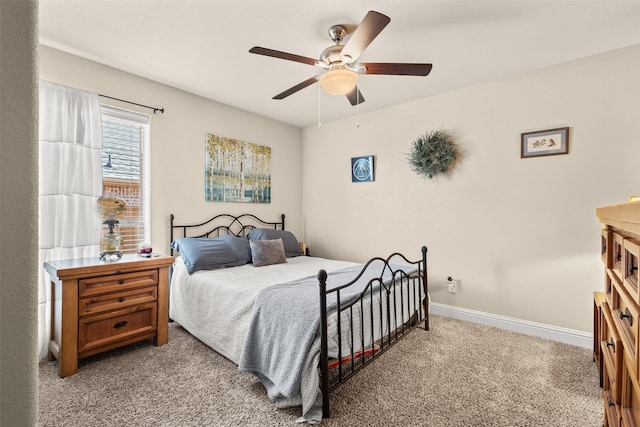 carpeted bedroom featuring ceiling fan and baseboards