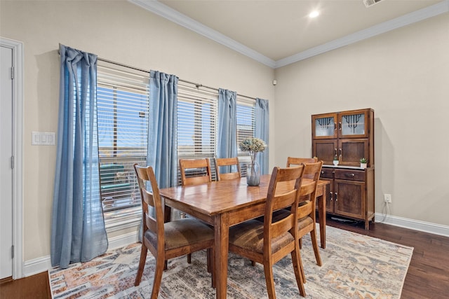 dining area featuring crown molding, baseboards, and dark wood-type flooring