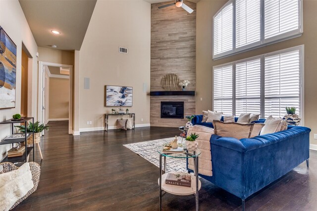 6005 Monte Cristo Ln, Plano, TX 75024 - living area featuring a towering ceiling, a tiled fireplace, baseboards, ceiling fan, and wood finished floors