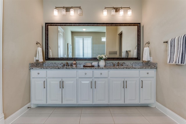 6005 Monte Cristo Ln, Plano, TX 75024 - bathroom with double vanity, tile patterned flooring, and baseboards