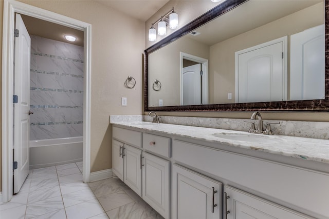6005 Monte Cristo Ln, Plano, TX 75024 - bathroom with double vanity, marble look tile flooring, baseboards, and bathtub / shower combination