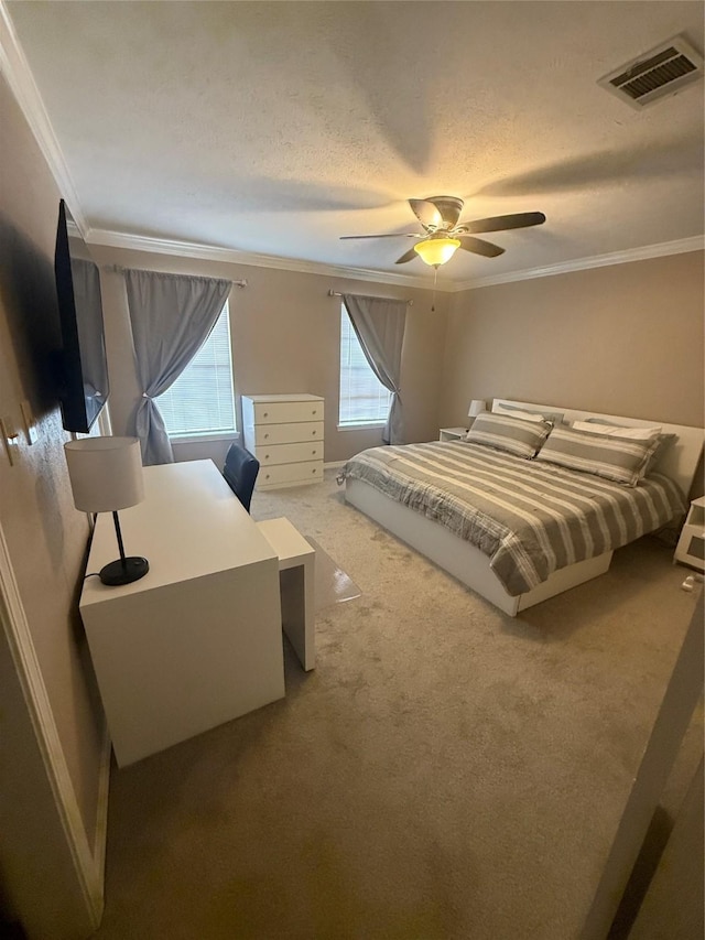 bedroom featuring carpet, visible vents, crown molding, and a textured ceiling