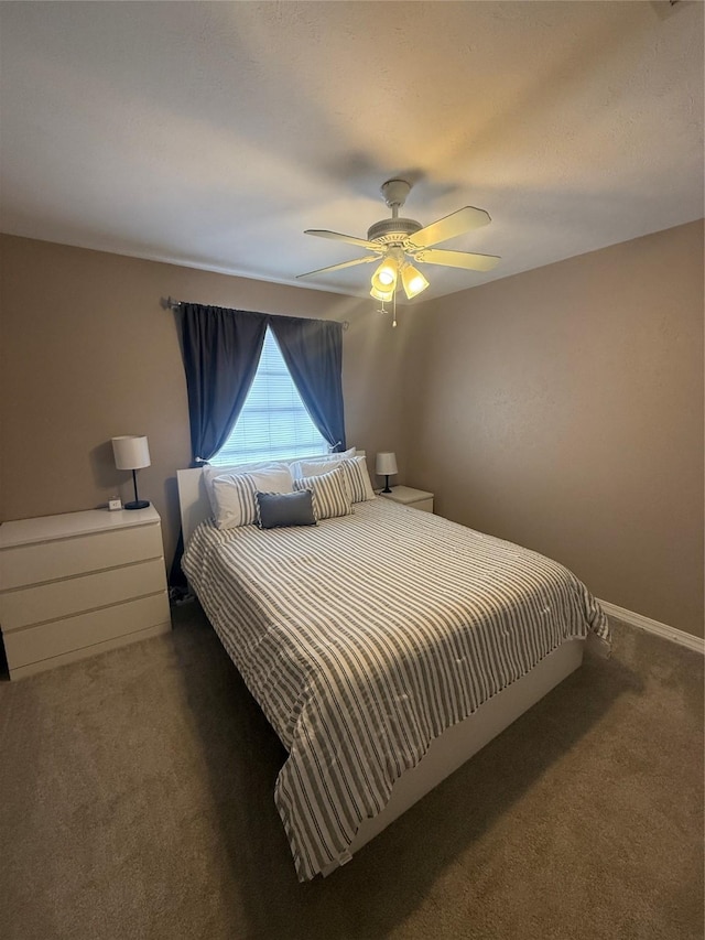 carpeted bedroom featuring a ceiling fan and baseboards