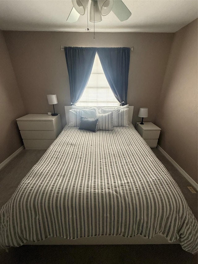 carpeted bedroom featuring a ceiling fan and baseboards