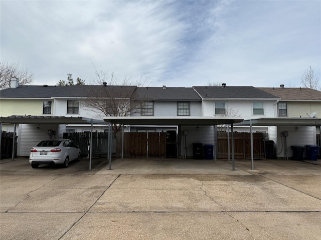 view of front of property featuring a carport and fence